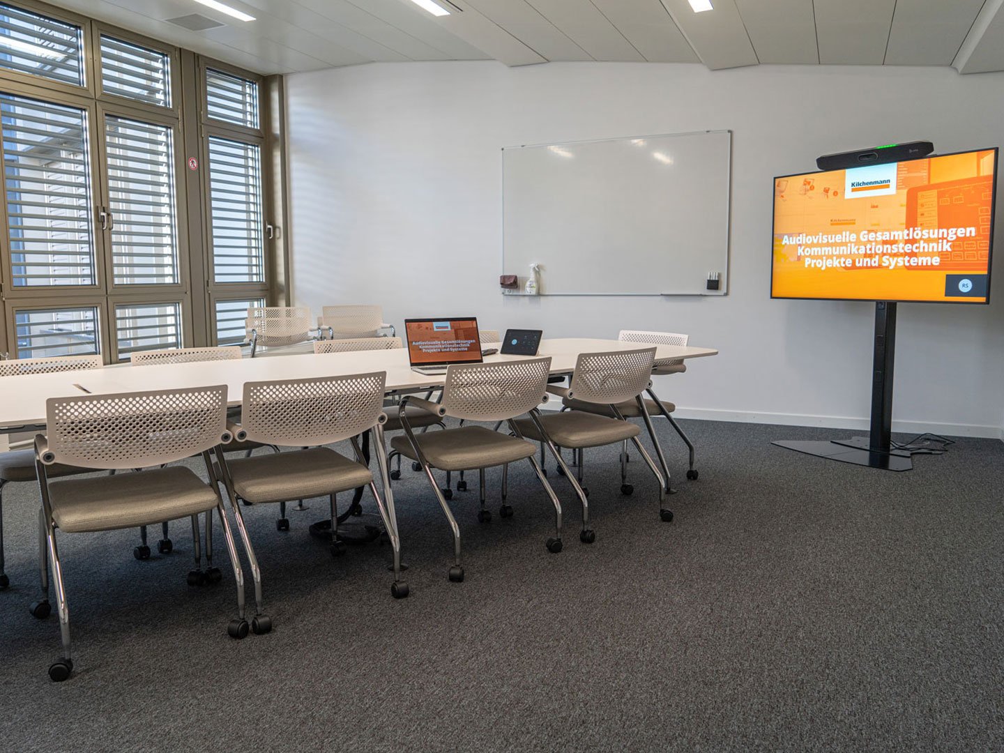 Reference image of furniture in a meeting room with a display